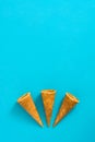 Empty summer ice cream cornets on blue background