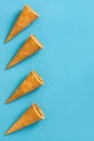 Empty summer ice cream cornets on blue background