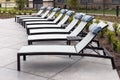 Empty sun loungers in the backyard of the residential complex, recreation area, many deck chairs