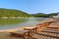 Empty sun loungers on the cypress lake in Sukko. Anapa. Russia