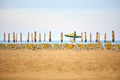 Empty sun lounges and closed parasols on the beach Royalty Free Stock Photo