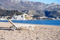 Empty sunbed on the deserted sandy beach, blue bay, beautiful sea view