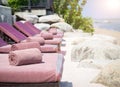 Empty sunbed with wrapped towels on a beautiful beach