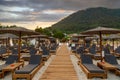 Empty sunbeds in a beach at sunset Thassos island, Greece, holiday destination