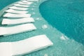 Empty sunbeds by the resort pool Royalty Free Stock Photo