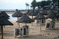 Empty sunbeds on a tropical beach, sandy beach by the sea. Summer vacation and holiday idea for tourism, pandemic, quarantine, Royalty Free Stock Photo