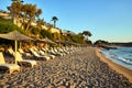 empty sunbeds and umbrellas on a sandy beach waiting for tourists on Zakynthos island Royalty Free Stock Photo