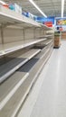 Empty Supermarket Shelves. Bare shelves and product shortages at grocery stores due to truck drivers strike.