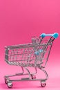 Empty Supermarket Shopping Cart  on Pink Pastel Background Royalty Free Stock Photo