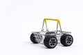 Empty supermarket shopping cart with wheels from a car on a white background. Royalty Free Stock Photo