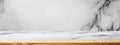 Empty surface of a natural stone table or countertop featuring a wooden base, set against a marble wall background, providing an Royalty Free Stock Photo