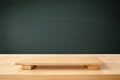 Empty sushi board on wood table with blackboard backdrops. Top view of plank wood for graphic stand product, interior design or