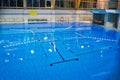 Empty swimming pool, clear water surface.