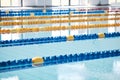 Empty, swimming pool or lines in water for race or racing lanes for fitness or underwater sports. Background, blue or Royalty Free Stock Photo