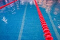 empty swimming pool with many lanes.An empty sports pool with a red dividing path. Blue water. Selective focus.Track and Royalty Free Stock Photo