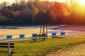 Empty swimming pool with red lifeguard stand in the autumn sundown. Very large swimming pool in the fall sunset. Royalty Free Stock Photo