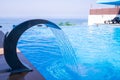 Empty Swimming pool with waterfall jet and jacuzzi in action.Hydrotherapy waterfall. summer sunny day. Seaside vacation Royalty Free Stock Photo