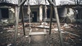 Empty swing set positioned in front of a bombed house, representing the profound loss and devastating effects of war on childhood Royalty Free Stock Photo