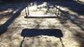 Empty Swing Set in a Sunlit Park Royalty Free Stock Photo