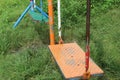 Empty swinging swing in the playground