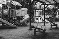 Empty swings on deserted kindergarten playground. Unattended slide and swing set during coronavirus outbreak. Closed for children Royalty Free Stock Photo