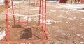 Empty swings on the playground fenced with tape for not using them during self-isolation due to coronavirus in 2020