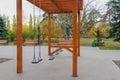 Empty swings on playground during quarantine or beginning or ending of school semester Royalty Free Stock Photo