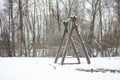 Empty swings from wood in winter Royalty Free Stock Photo