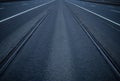 A symmetrical road with rails extending far beyond the horizon Royalty Free Stock Photo
