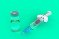 Empty syringe with vial closeup isolated on green background, High resolution, Medical concept. Royalty Free Stock Photo