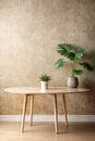 Empty table against beige textured wall background. Composition with glossy leaves on the wall Royalty Free Stock Photo