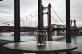 Empty table with blurred bridge background, architectural elegance concept