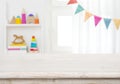 Empty table with blurred children toy shelf and window background Royalty Free Stock Photo