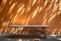 Empty table on bright brown wall background Royalty Free Stock Photo