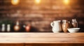 empty table with a candle and cups in the background on wooden counter with blurred light
