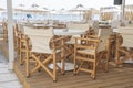 Empty table and chairs in restaurant, Greece. Beach cafe near sea, outdoors. Travel and vacation concept Royalty Free Stock Photo