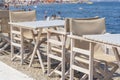 Empty table and chairs in restaurant, Greece. Beach cafe near sea, outdoors. Travel and vacation concept Royalty Free Stock Photo