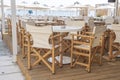 Empty table and chairs in restaurant, Greece. Beach cafe near sea, outdoors. Travel and vacation concept Royalty Free Stock Photo