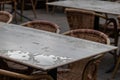 Empty table and empty chairs of summer restaurant or beer garden in summer on rainy day with raindrops and no guests, no income on Royalty Free Stock Photo
