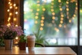 empty table corner, blurred string lights and cafe decor Royalty Free Stock Photo