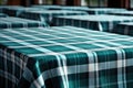 Empty table covered with blue and white chequered tablecloth next to white wooden chair. Royalty Free Stock Photo