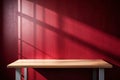 Empty Table with Dark Red Wall and Window Light Shadow Royalty Free Stock Photo