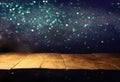 Empty table in front of black and gold glitter lights background Royalty Free Stock Photo