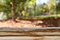 Empty table in front of blurry autumn background. Ready for product display montage Royalty Free Stock Photo