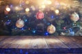 Empty table in front of christmas tree with decorations background. For product display montage Royalty Free Stock Photo