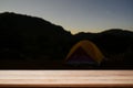 Empty table montage with Camping tent mountain view and star with night time