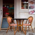 Empty table with two chairs at old cafe