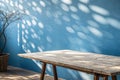 Empty table on smooth blue wall background Royalty Free Stock Photo