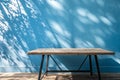 Empty table on smooth blue wall background Royalty Free Stock Photo