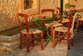 Empty table at street village restaurant, Crete, Greece. Sunset Royalty Free Stock Photo